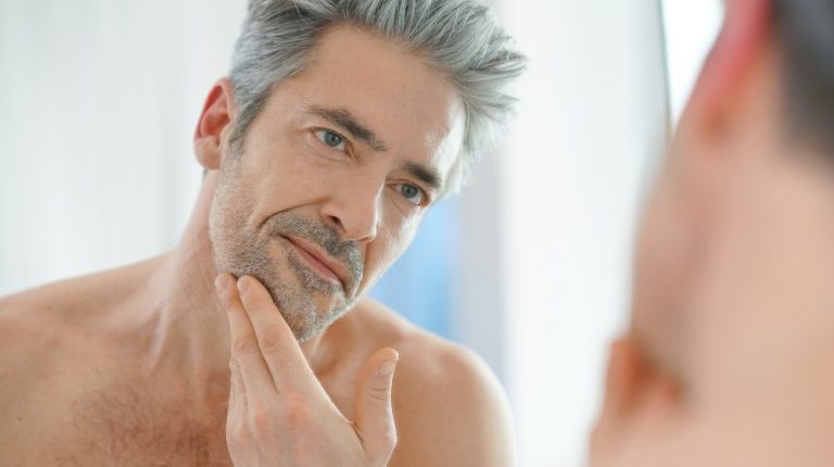 Portrait of mature man in front of mirror | Can Spermidine Help Slow Down Aging?