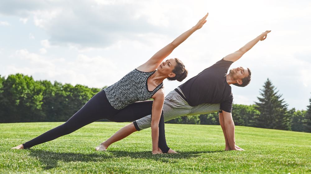 couple doing yoga outdoor | Immunosenescence: The Connection Between Metabolism, Immune System, and Aging