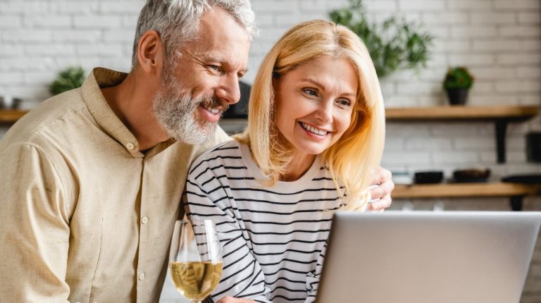 middle aged couple looking at their computer | How to Measure Your Immunological Age and Prevent Disease