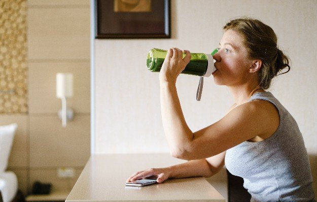 woman drinking healthy juices after workout | 5 Proven Health Benefits Of Liquid Chlorophyll