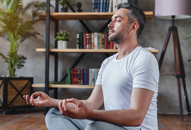 Middle aged man meditating at his living room floo…tting-ss-1.Biohacking Your Brain by Meditation | 4 Genius Ways to Biohacking Your Brain