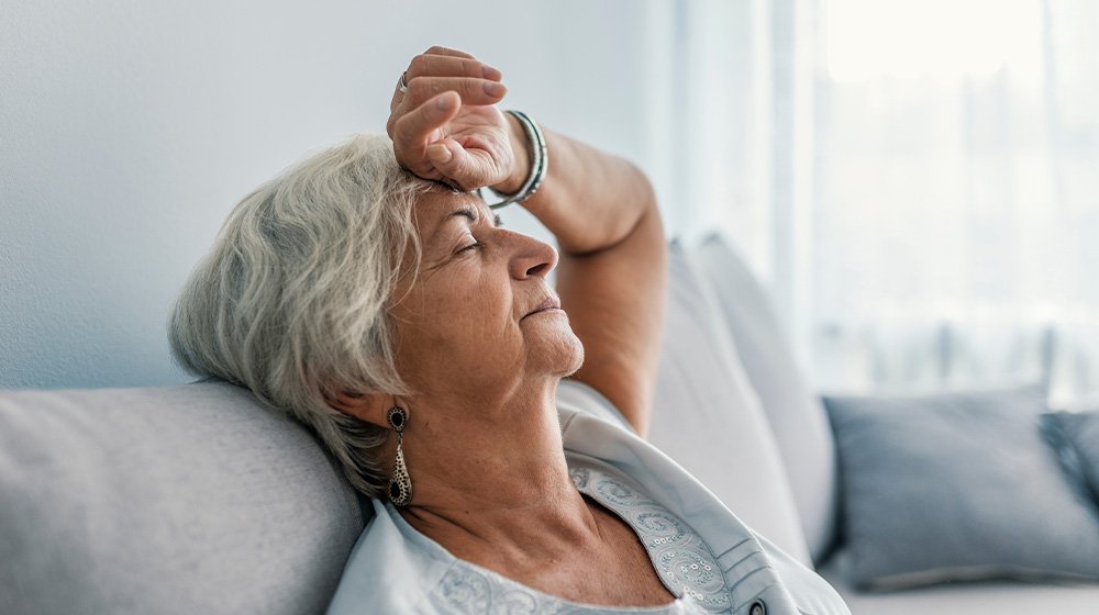 Thoughtful senior woman relaxing on bed-ss-What Is…sfunction? Everything You Need to Know-feature | What Is Mitochondrial Dysfunction? Everything You Need to Know