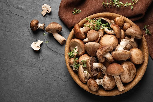 Different-fresh-wild-mushrooms-in-bowl-Mushrooms-ss-body | 5 Best Anti-aging Foods for Gut Health