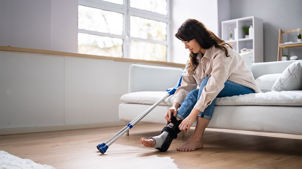 Woman-With-Leg-Injury-Using-Crutches-At-Home---What-is-a-Comminuted-Fracture-&-How-It-Affects-Adults