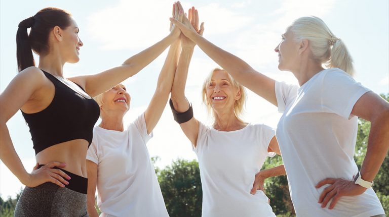 Joyful-nice-active-women-looking-at-each-other-and-giving-a-high-five-while-being-ready-to-train-How-to-Slow-Down-Aging-Through-Stress-Manipulation