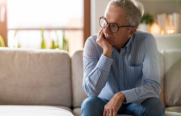 Worried-senior-man-sitting-alone-in-his-home-How-Does-Chronic-Stress-Accelerate-Biological-Aging