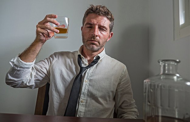 alcoholic-man-in-lose-necktie-drinking-desperate-holding-whiskey-glass-thoughtful-drunk-completely-wasted-in-alcohol-addiction-concept-What-Causes-Increased-Intestinal-Permeability