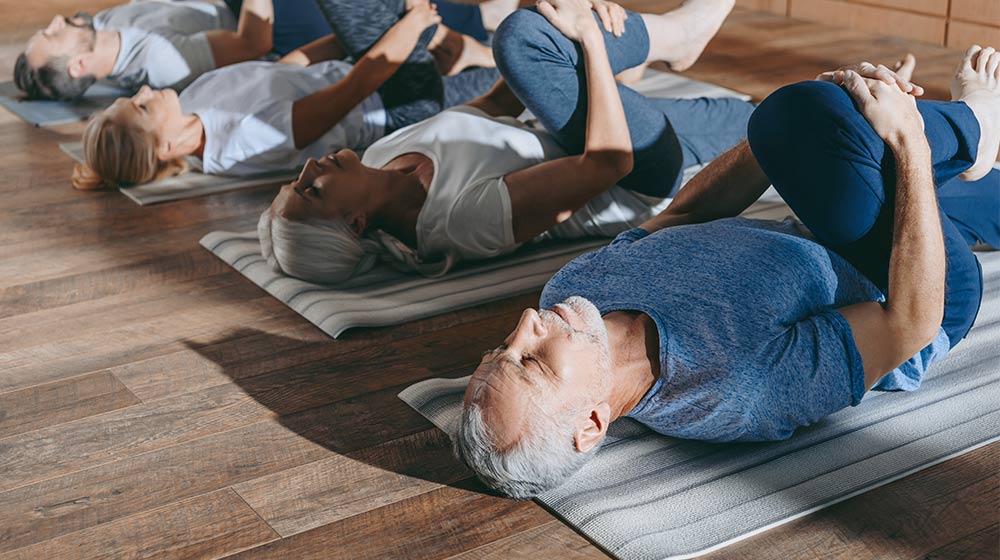 group-of-senior-people-stretching-in-yoga-mats-in-studio-New-Study-Shows-How-to-Repair-Damaged-Cells-Improve-Longevity