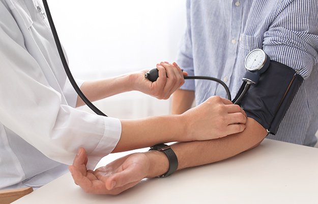 Doctor-checking-patients-blood-pressure-in-hospital-closeup-Advantages-of-Precision-Cardiovascular-Medicine