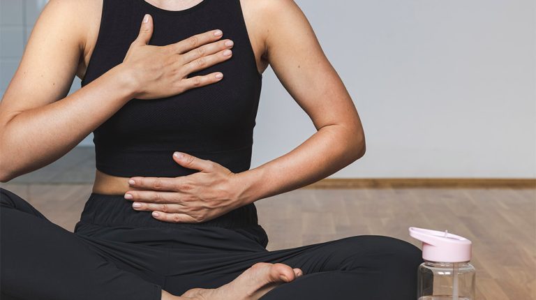 Woman-doing-breathing-exercise-sitting-in-lotus-position-How-Precision-Cardiovascular-Medicine-Helps-Prevent-the-Development-of-Heart-Diseases