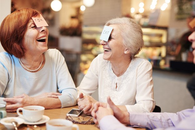 two-senior-women-laughing-during-game-Mental-Health-Challenges-Not-a-Typical-Aspect-of-Aging-ss