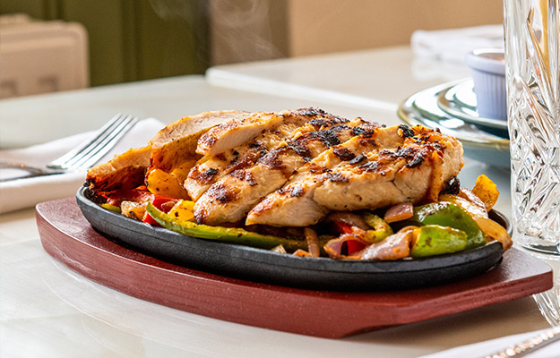 a-delicious-grilled-chicken-on-a-sizzling-plate---Role-of-Protein-Intake-for-Muscle-and-Longevity---px-body