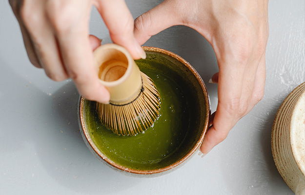 person-preparing-tea-in-bowl-for-tea-ceremony--Green-Tea-Extract---px-body