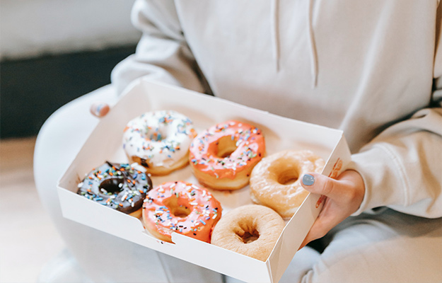 Content-chubby-woman-holding-box-with-donuts-What-Causes-Fatty-Liver-Disease-px-body
